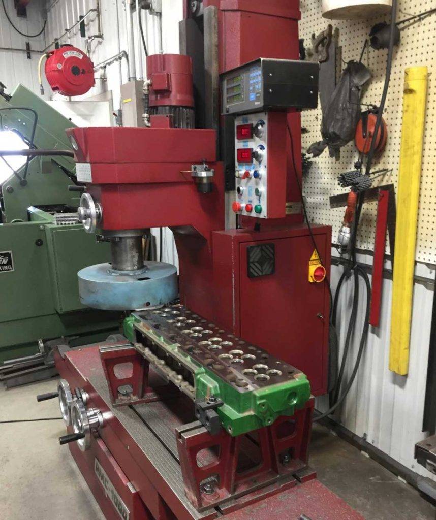 Red cylinder boring machine in workshp